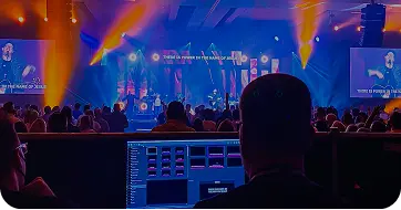 Church tech team member managing audio and visual equipment during a worship service