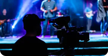 Church volunteer operating a video camera during a service